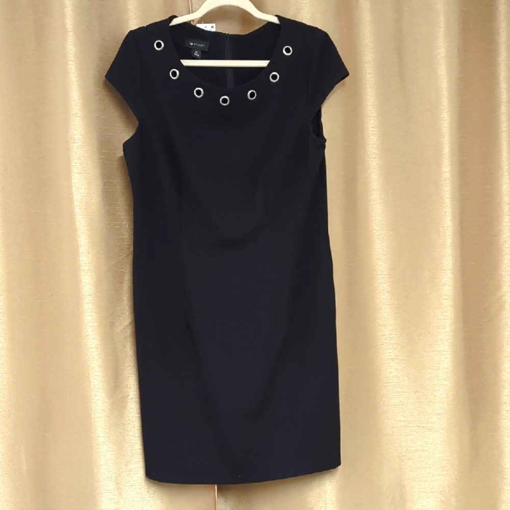 Elegant Black Dress with Eyelet Detail Size XL also Has Pockets On Both Sides.